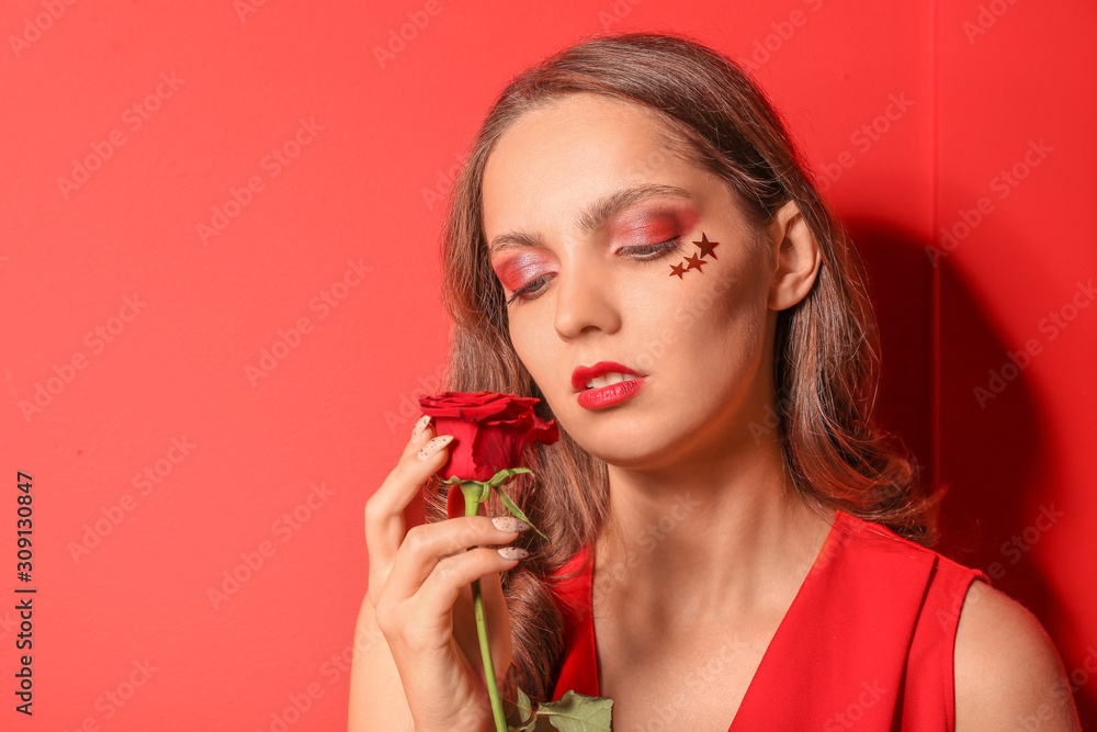 Fashionable young woman with flower on color background Fashionable young woman with flower on color background