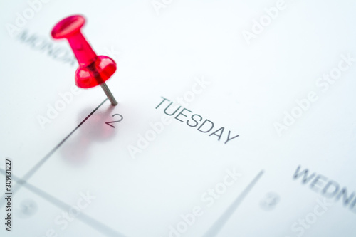 Photos Red push pin on calendar 2nd day of the month