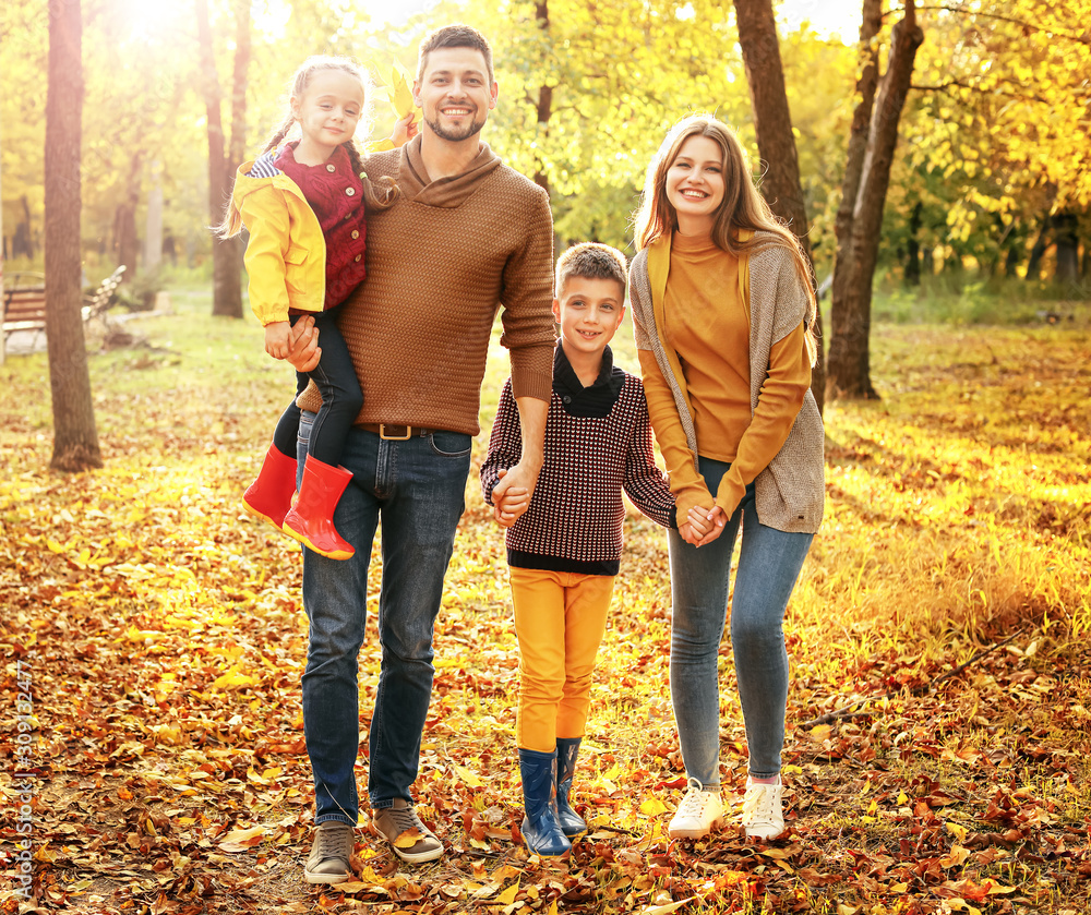 Fototapeta premium Happy family walking in autumn park