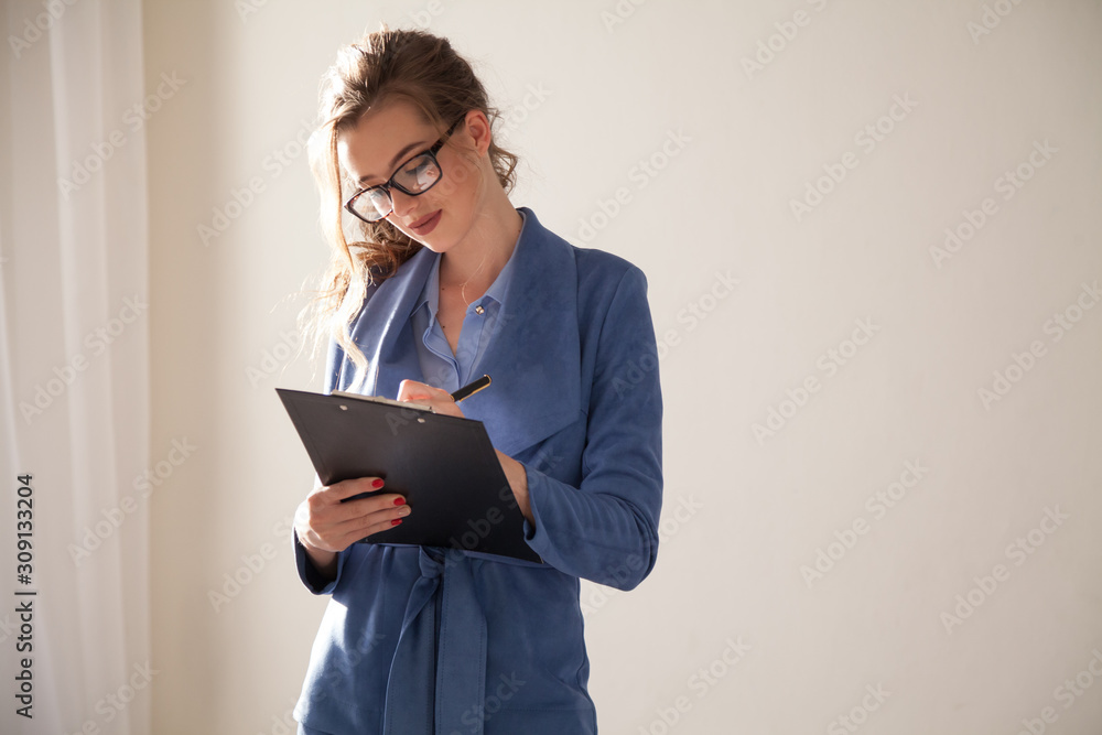 Beautiful business woman in business suit talks in the office Beautiful business woman in business suit talks in the office