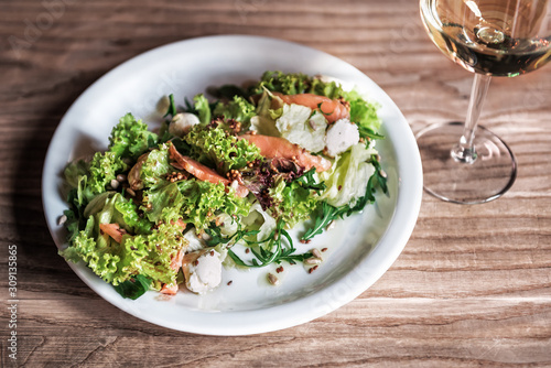 fresh salad with salmon and wine