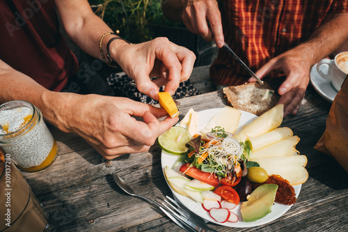 Sticker Midsection of two persons eating breakfast together