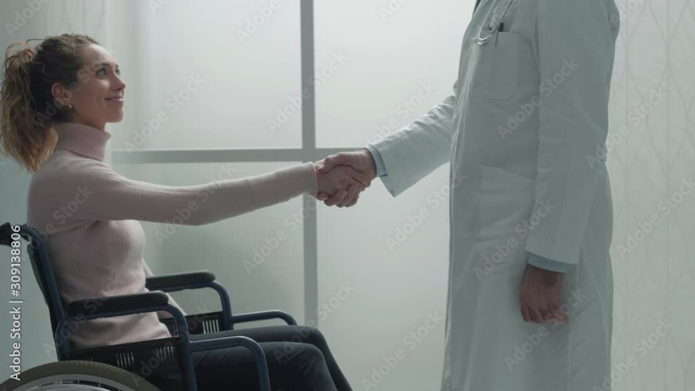 Doctor shaking hand with a disabled patient at hospital Doctor shaking hand with a disabled patient at hospital