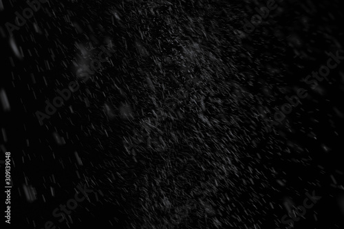 Snow from spray can stream out then fall down slowly spread all around with some big point on black background for overlay effect