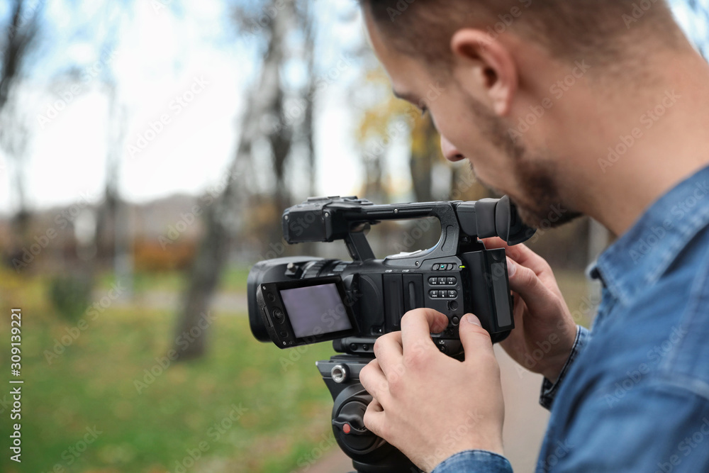 Video operator with camera working in park Video operator with camera working in park