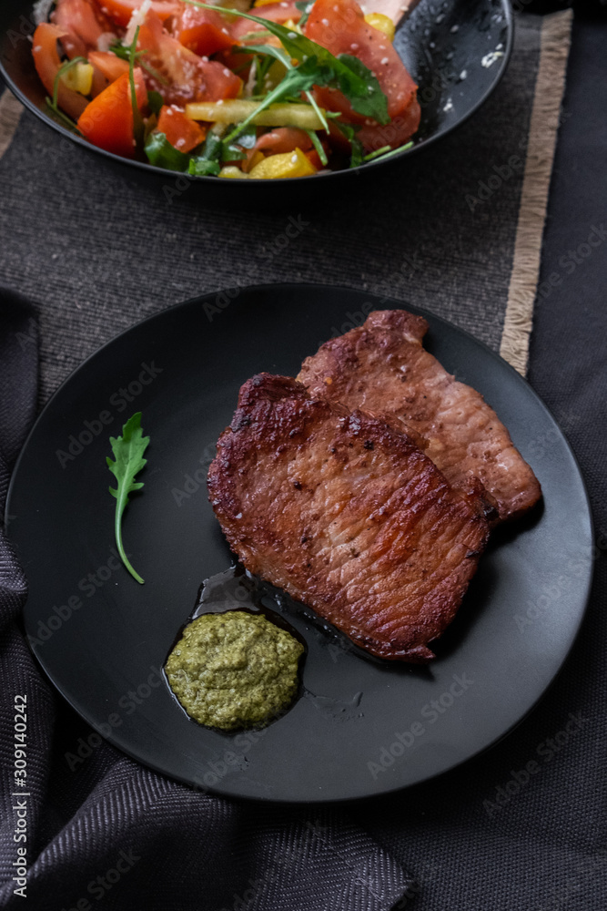 fried meat with vegetable salad and pesto. fried meat with vegetable salad and pesto.
