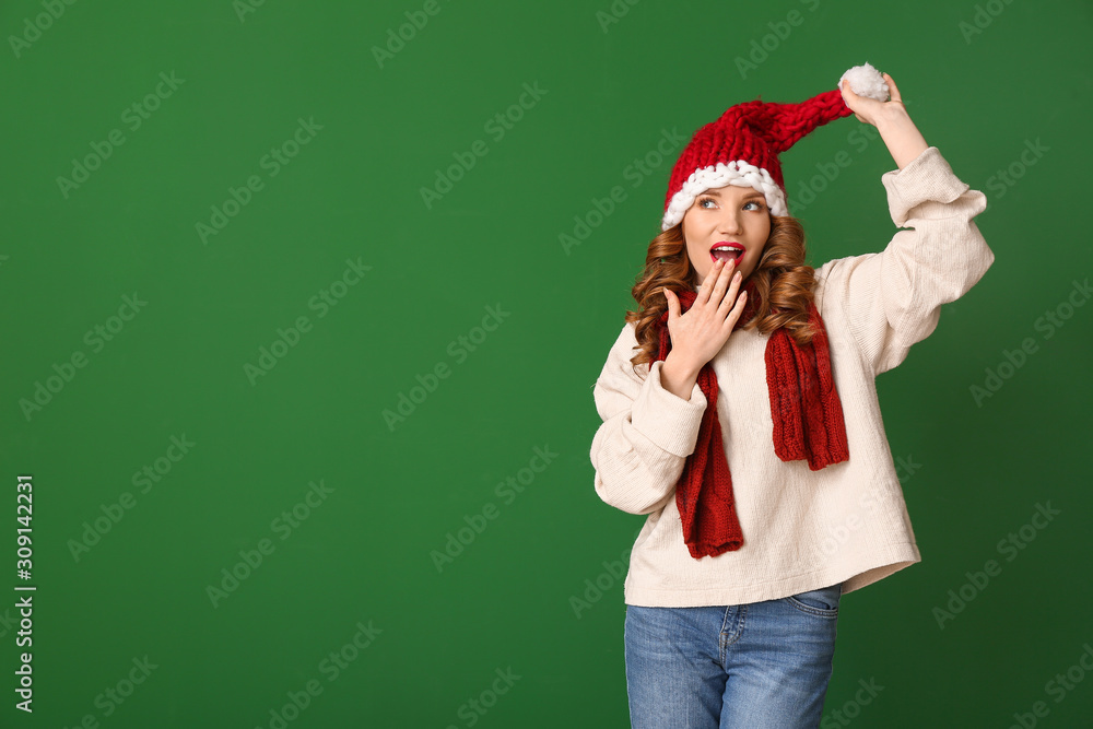 Surprised young woman in winter clothes on color background Surprised young woman in winter clothes on color background