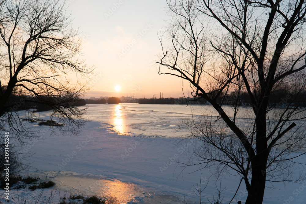 sunset over a river covered in ice and snow sunset over a river covered in ice and snow