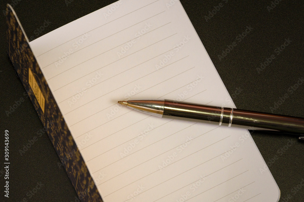 Open empty white notebook and pen, top view, copy space Open empty white notebook and pen, top view, copy space
