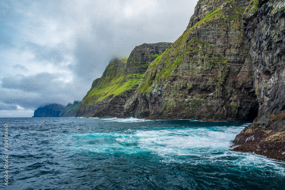 Steep coastline of Faroe islands with spectacular cliffs