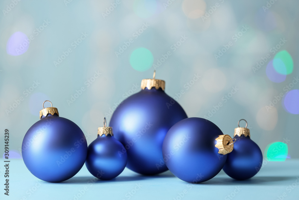 Beautiful Christmas balls on table against blurred lights Beautiful Christmas balls on table against blurred lights