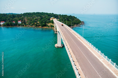 Scenic Aerial View of Bridge over Sea, bridge TECHO MORAKAT to Snake island KOH PUOS. Sihanoukville. Cambodia. Top view aerial view. photo