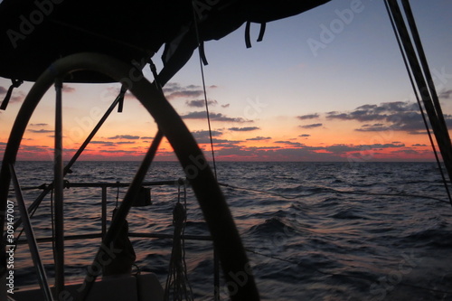 Sailboat sailing in sunset © sigalglot