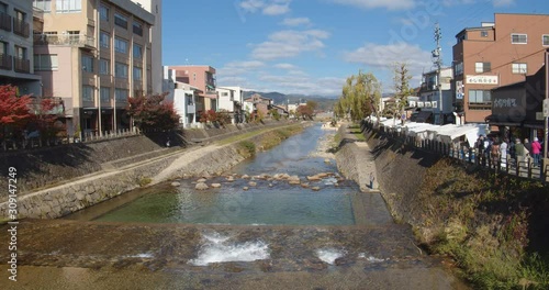 Cloudscape timelapse over Miyagawa river in Takayama, a city in the northern mountainous Hida region of Gifu Prefecture, located in the heart of the Japan Alps. photo