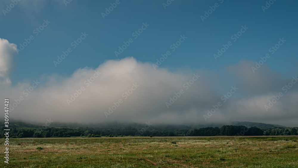 Morning clouds in the meadow. Landscape in the countryside. Morning clouds in the meadow. Landscape in the countryside.