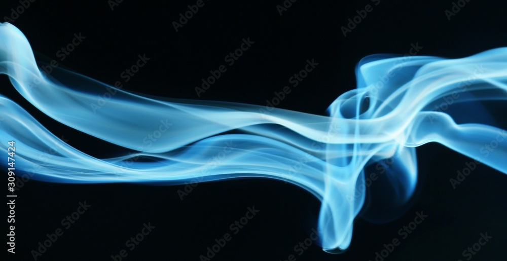 Naklejka premium abstract blue smoke on black background