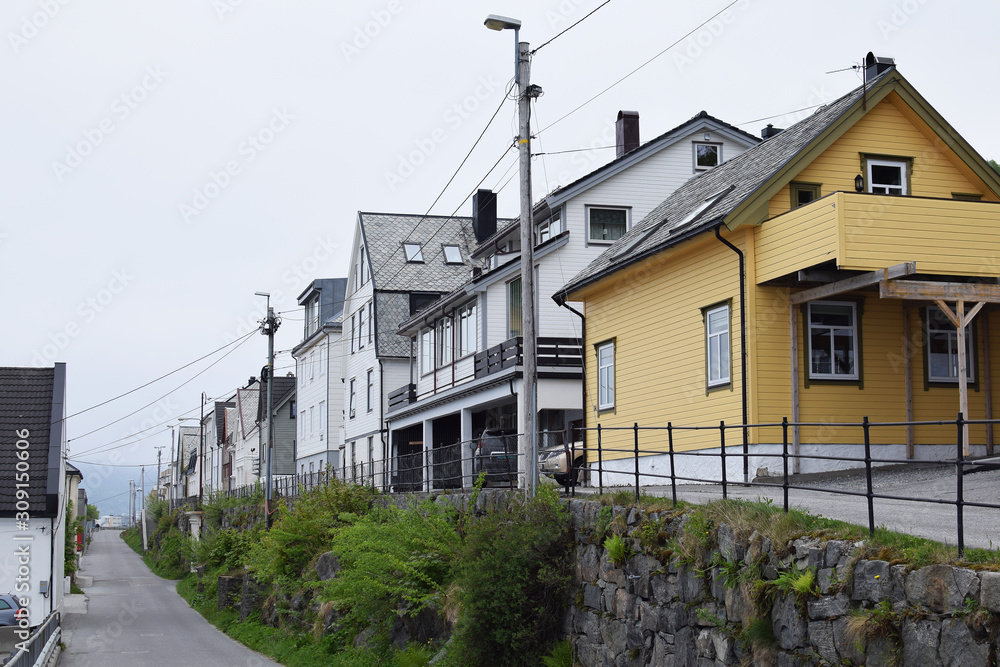Quiet street with traditional wooden Norwegian houses, Alesund. Typical Norwegian wooden houses