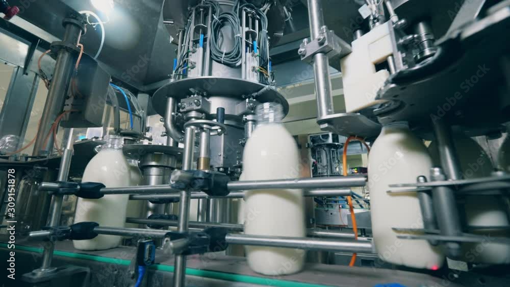 Bottles with milk moving on a factory line. Bottles with milk moving on a factory line.