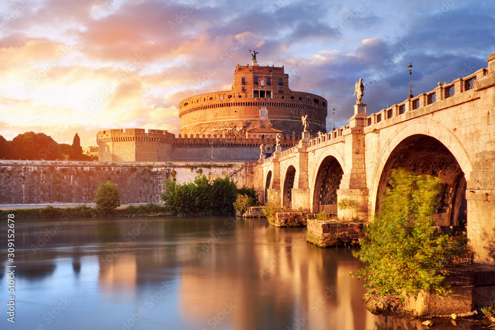 Saint Angelo Castle and bridge over the Tiber river in Rome, Italy, at sunset with beautiful reflections in calm water