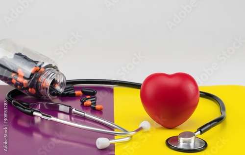 Toy heart and stethoscope on a colored background. Concept healthcare. Cardiology - care of the heart
