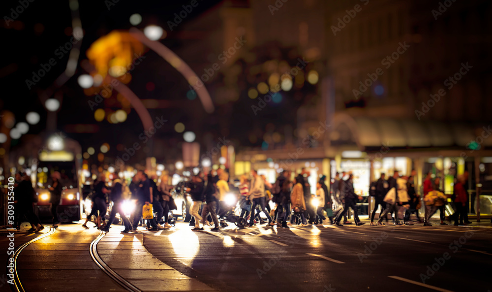 pedestrians crossing night street in the city 