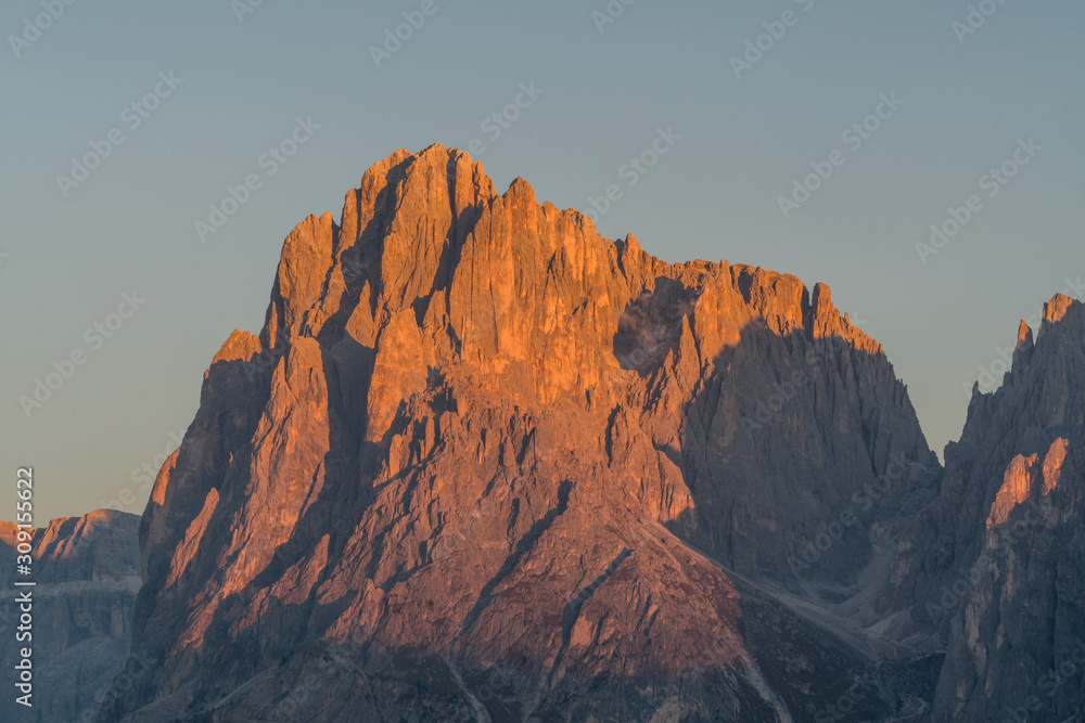 Distance view of the details of the Plattkofel mountain peak during the sunset with red cliffs on Alpe di Siusi, South Tyrol, Italy