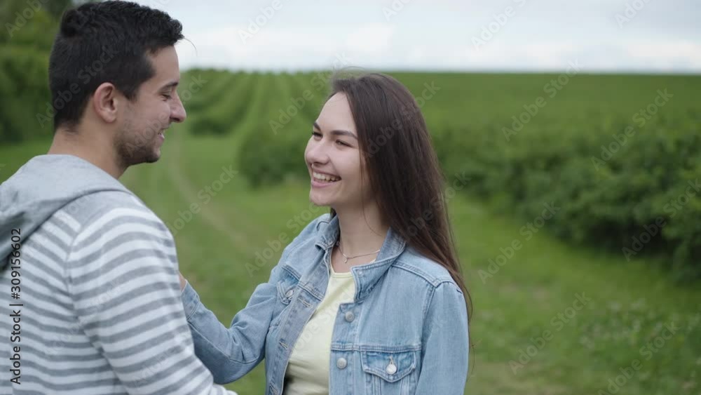 Lovely girl kisses her boyfriend on nature. 4K Lovely girl kisses her boyfriend on nature. 4K