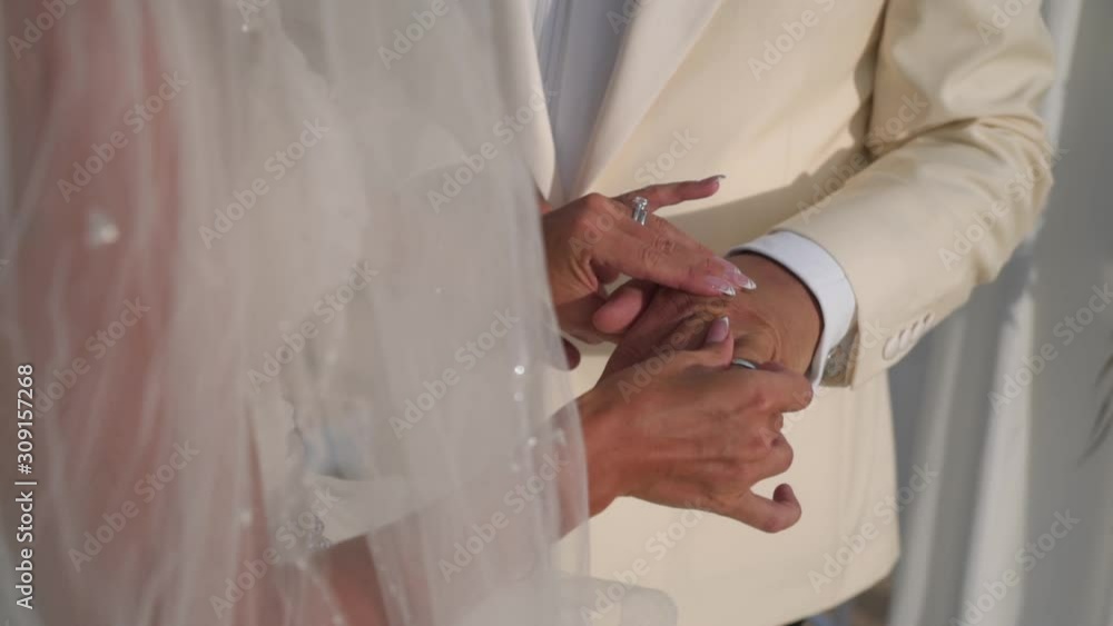Man and woman exchange rings. Wedding ceremony, Close up female hands Man and woman exchange rings. Wedding ceremony, Close up female hands