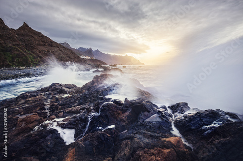 view of wild Benijo beach with big waves and black sand on the north coast of the Tenerife island, Spain - long exposure image