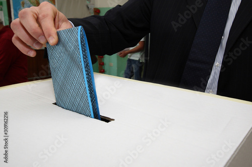 Quadro su tela political elections - the ballot paper in the hand as it is about to be inserted