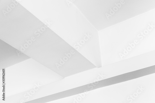 Abstract white geometric interior fragment with ceiling beams