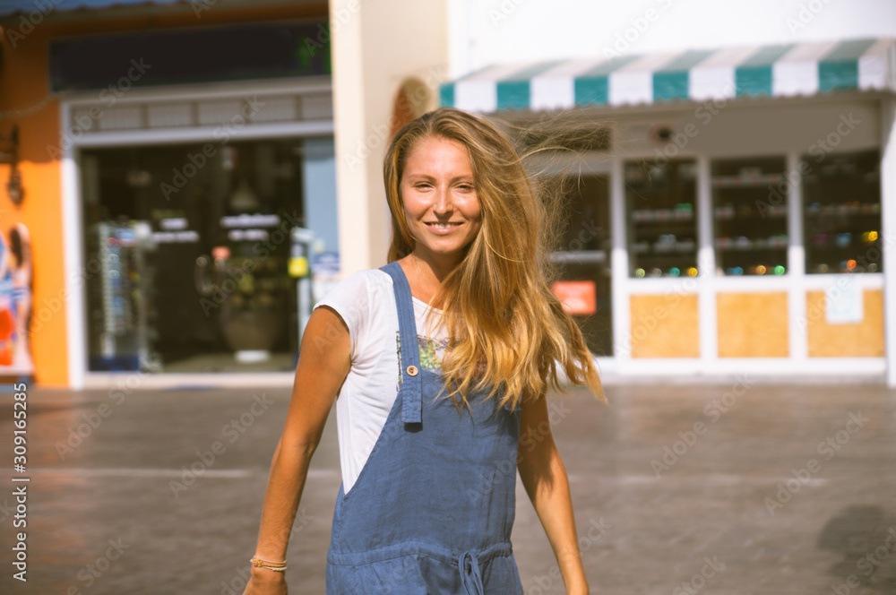 Beautiful blonde girl in modern fashion on a background of palm trees, a hippie car. Dissolute girl with happy emotions. Beautiful blonde girl in modern fashion on a background of palm trees, a hippie car. Dissolute girl with happy emotions.