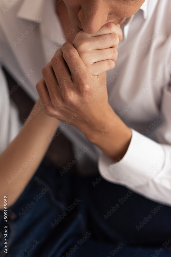 Cropped view of man kissing hand of girlfriend