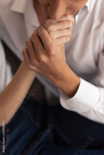 Cropped view of man kissing hand of girlfriend