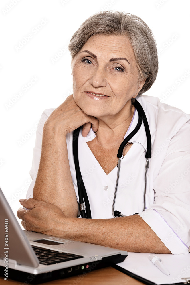 Close-up portrait of confident female doctor sitting at table with laptop Close-up portrait of confident female doctor sitting at table with laptop