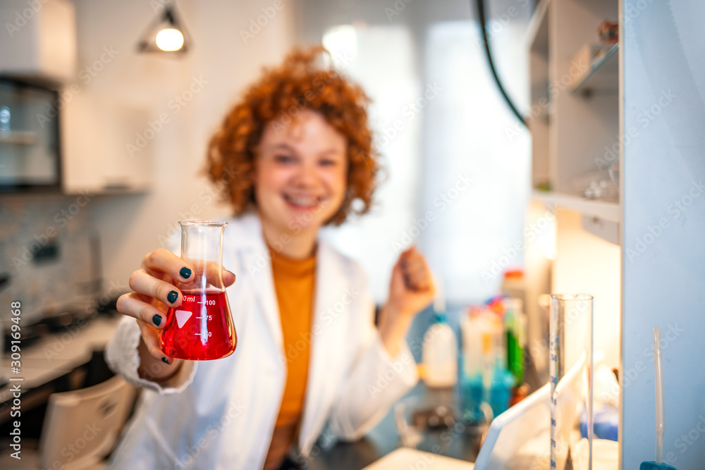 Lovely day in the laboratory. Experienced female scientist is working in laboratory. A female medical or scientific researcher or woman doctor looking at a test tube Lovely day in the laboratory. Experienced female scientist is working in laboratory. A female medical or scientific researcher or woman doctor looking at a test tube