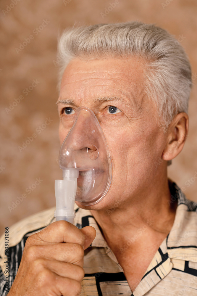 Close-up portrait of sick senior man with inhaler Close-up portrait of sick senior man with inhaler