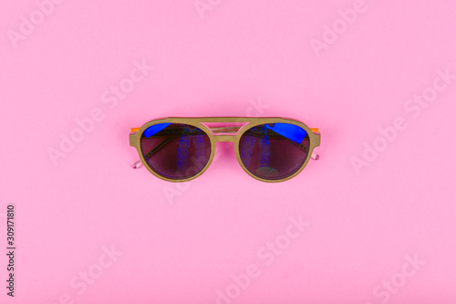 blue glasses on a pink background. Flat lay. Blue glasses on glasses. reflection. glamor.