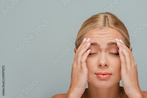 woman with wrinkles on face isolated on grey