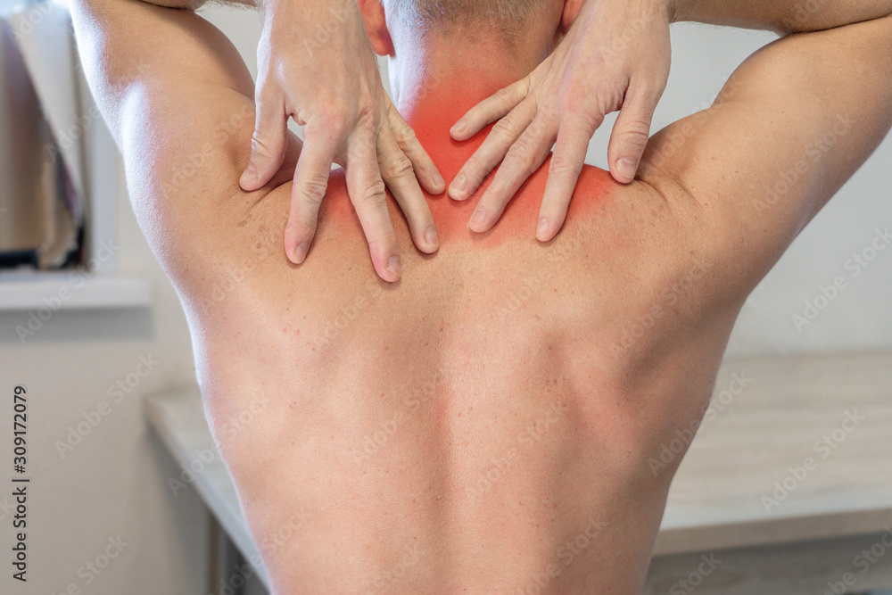 man rubs his hands with painful area in upper back. man suffering from neck and shoulder pain. man rubs his hands with painful area in upper back. man suffering from neck and shoulder pain.