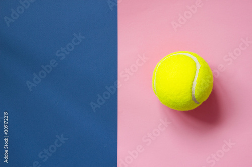 Tennis balls on blue and pink background with copy space. Color of the year 2020, horizontal format photo. Active lifestyle concept. Sports equipment, top view © Olha Kozachenko