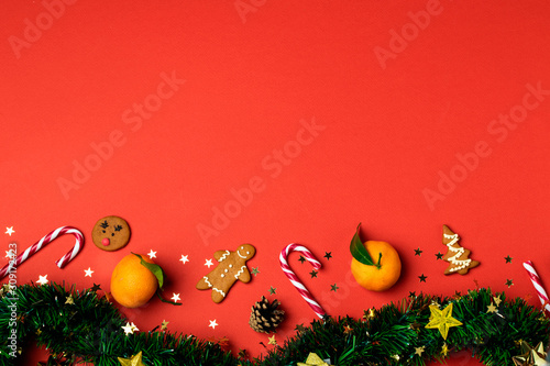 Christmas composition, tinsel, gingerbread, cookie cutter, candy cane, tangerine, ornaments, rolling pin, pinecone