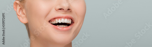 panoramic shot of cheerful girl laughing isolated on grey