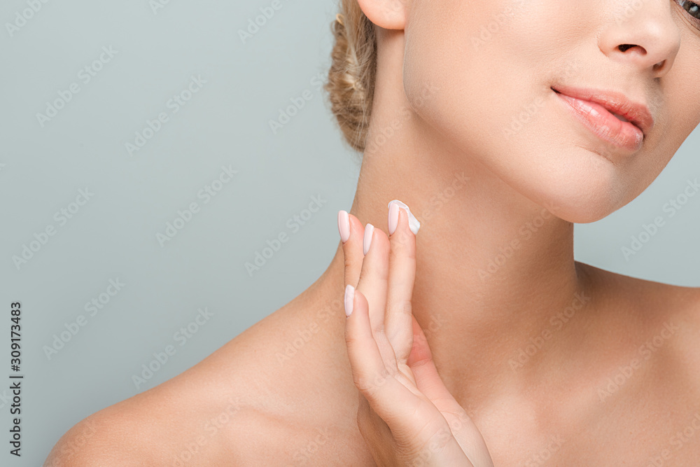 cropped view of woman applying cosmetic cream on neck isolated on grey cropped view of woman applying cosmetic cream on neck isolated on grey