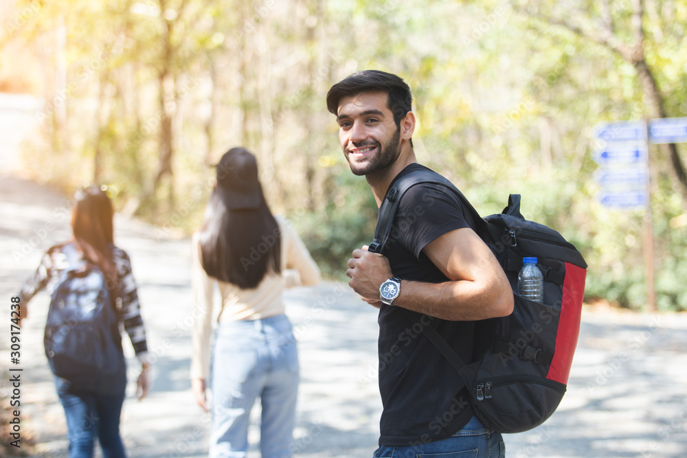 Fototapeta premium portrait man smile looking camera with backpack in nature travel.