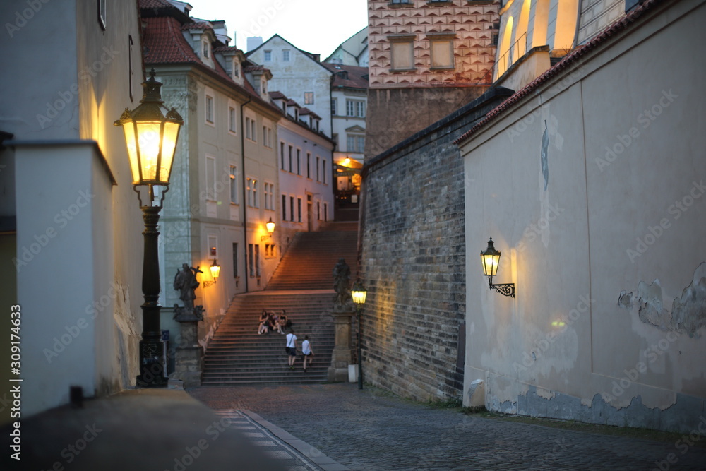 A lantern burning bright as dusk descends in Prague on a summer's evening