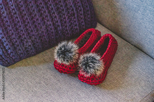 Fototapeta Naklejka Na Ścianę i Meble -  Crochet slippers with fur pompom