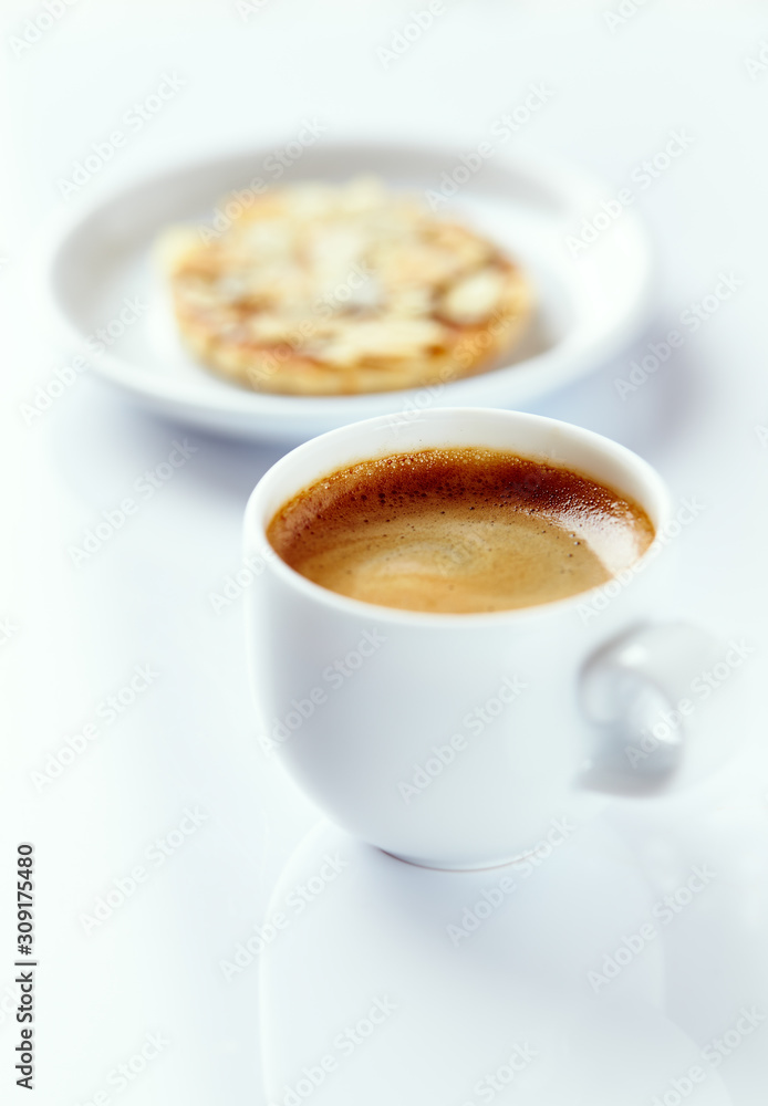 Cup of coffee and almond cookies on white background. Close up. Cup of coffee and almond cookies on white background. Close up.