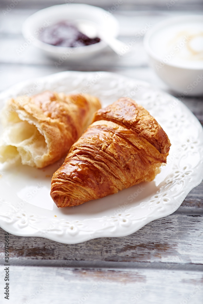 Croissant with coffee and jam. White wooden background. Croissant with coffee and jam. White wooden background.