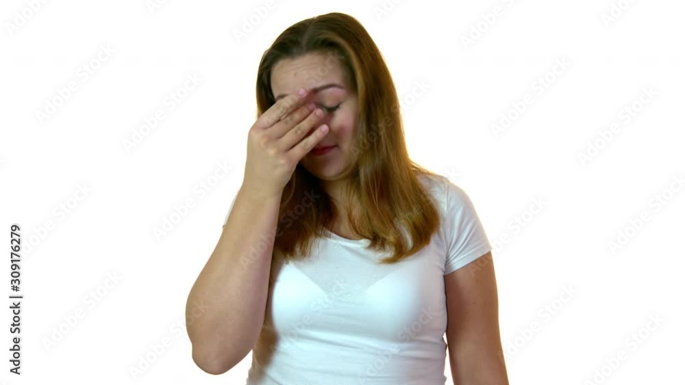 Plus size woman in studio feeling discomfort and suffering sinus chronic inflammation. Showing painfull expression and touching her temple. Plus size woman in studio feeling discomfort and suffering sinus chronic inflammation. Showing painfull expression and touching her temple.